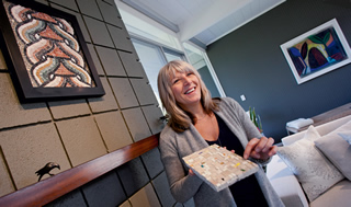 Mosaicist Lillian Sizemore shows off examples of her work in her Lucas Valley Eichler living room.