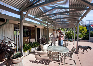 Ted Bloyd and Julia Smetana on the patio of their Terra Linda two-story, which rests against a hillside. 