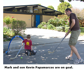 dad and son playing on street