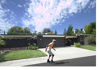 man rollerskating past suthland park houses